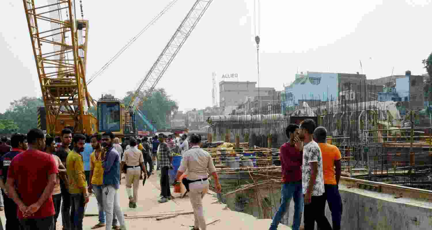 People gather at Patna Metro tunnel construction site where two people died and many were injured. People gather at Patna Metro tunnel construction site where two people died and many were injured.