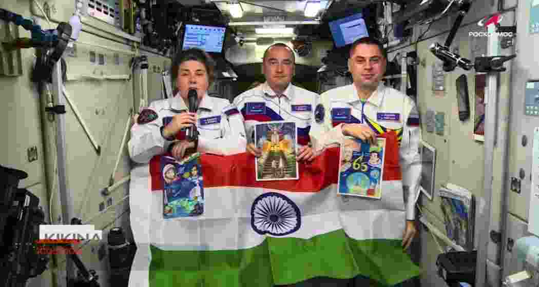 Russian cosmonauts aboard the International Space Station hold the Indian tricolour while extending Independence Day greetings to India. Russian cosmonauts aboard the International Space Station hold the Indian tricolour while extending Independence Day greetings to India.