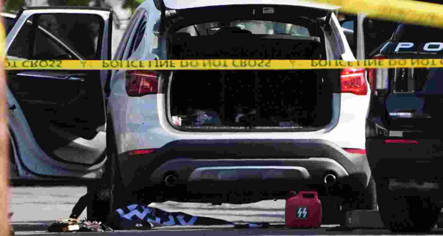 A vehicle's hatch and doors are opened near where a body of one of the shooters was placed near the scene of a shooting outside the Islamic Center of San Diego Monday, May 18, 2026, in San Diego. A vehicle's hatch and doors are opened near where a body of one of the shooters was placed near the scene of a shooting outside the Islamic Center of San Diego Monday, May 18, 2026, in San Diego.