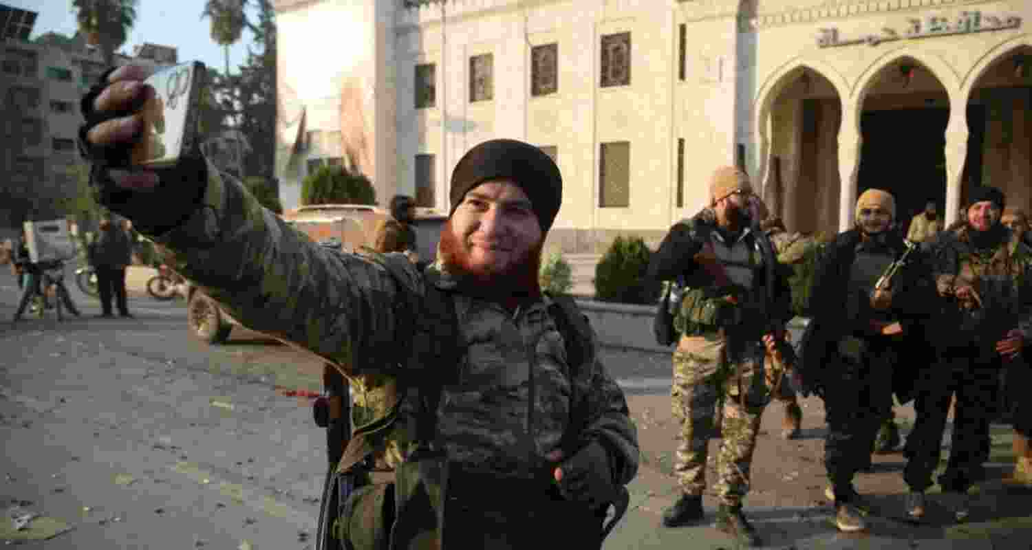 A rebel fighter takes a selfie after the forces captured the city of Hama, Syria. A rebel fighter takes a selfie after the forces captured the city of Hama, Syria.