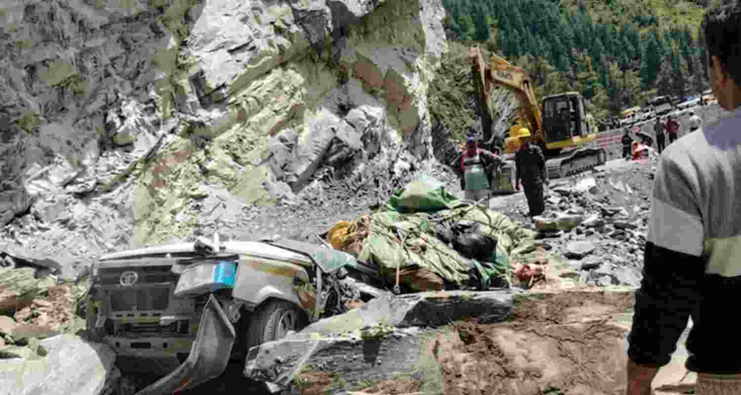 The damaged taxi is seen trapped under debris after a landslide on the Udaipur-Killar road. The damaged taxi is seen trapped under debris after a landslide on the Udaipur-Killar road.
