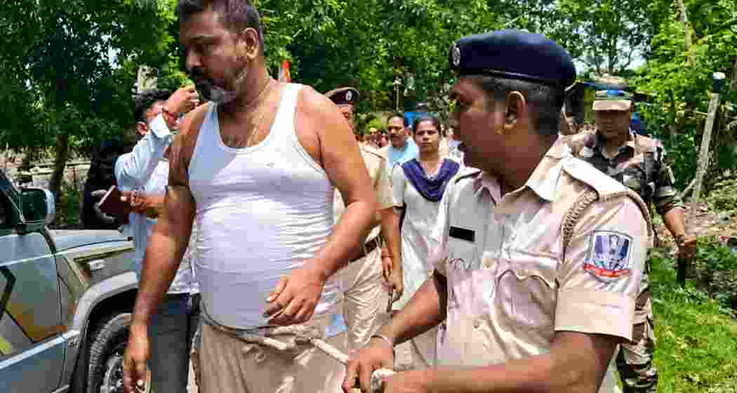 Police personnel escort TMC youth leader Abhijit Roy, also known as Boni, through a locality in Kanchrapara with a rope tied around his waist after his arrest, drawing public attention and sparking political controversy. Police personnel escort TMC youth leader Abhijit Roy, also known as Boni, through a locality in Kanchrapara with a rope tied around his waist after his arrest, drawing public attention and sparking political controversy.