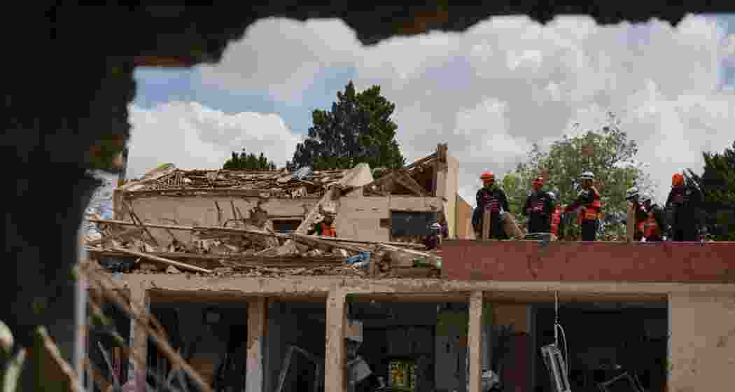 Israeli security forces survey the site that was struck by an Iranian missile in Dimona, southern Israel on Sunday. Israeli security forces survey the site that was struck by an Iranian missile in Dimona, southern Israel on Sunday.