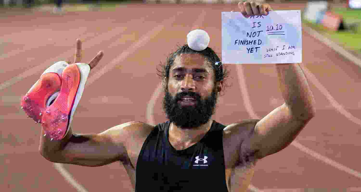 After the race, Gurindervir Singh celebrated holding up his race bib, inscribed with the message, "10.10. Task is not finished yet. Wait, I am still standing." After the race, Gurindervir Singh celebrated holding up his race bib, inscribed with the message, "10.10. Task is not finished yet. Wait, I am still standing."