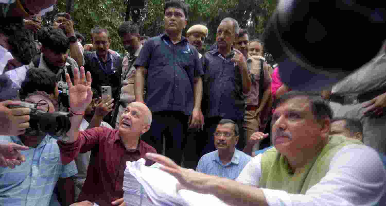 Former Delhi chief minister and AAP chief Arvind Kejriwal, party leaders Sanjay Singh and Manish Sisodia and others sit on Firoz Shah Road after being stopped by the police during their protest march towards the Prime Minister's residence in New Delhi on Tuesday. Former Delhi chief minister and AAP chief Arvind Kejriwal, party leaders Sanjay Singh and Manish Sisodia and others sit on Firoz Shah Road after being stopped by the police during their protest march towards the Prime Minister's residence in New Delhi on Tuesday.
